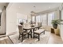 Bright dining room with a large table and bench seating for six at 6506 Barnstead Dr, Castle Pines, CO 80108