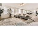Open concept living room featuring a sectional sofa and access to the kitchen at 6506 Barnstead Dr, Castle Pines, CO 80108
