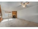 Living room featuring fireplace and carpet at 9691 W Chatfield Ave # E, Littleton, CO 80128