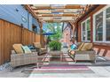 Inviting outdoor patio with comfortable seating beneath a pergola draped with lights at 1218 S Josephine St, Denver, CO 80210