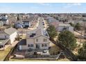 Aerial view of a home showing solar panels, a patio with furniture, and a fenced yard in a residential area at 3699 S Killarney St, Aurora, CO 80013