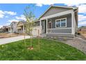 Street view of a single-Gathering home featuring a inviting front porch and manicured landscaping at 770 N Deer Park St, Watkins, CO 80137