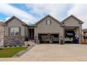 Beautiful home exterior with large multi-car garage and well maintained lawn and landscaping at 6899 Petunia Pl, Castle Rock, CO 80108
