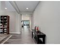 Spacious hallway featuring hardwood floors, neutral walls, and plenty of natural light at 6899 Petunia Pl, Castle Rock, CO 80108
