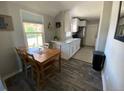 Cozy dining area with a modern kitchen featuring granite countertops and stainless steel appliances at 3993 Haddon Rd, Denver, CO 80205