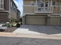 Spacious two-car garage with an attached balcony and stone accents at 1347 Carlyle Park Cir, Highlands Ranch, CO 80129