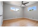 Light-filled bedroom featuring hardwood floors and a ceiling fan at 181 E 108Th Ave, Northglenn, CO 80233