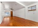 Sunny living room featuring hardwood floors and two large windows at 2515 Ames St, Edgewater, CO 80214