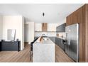 A modern kitchen featuring a spacious island, granite countertops, and stainless steel appliances at 9185 W Eaton St, Westminster, CO 80031