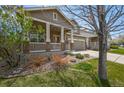 Beautiful home with a covered porch, landscaped front yard, and a welcoming facade at 11704 Hale Ct, Parker, CO 80138