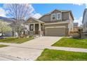 Inviting two-story home with a well-kept lawn, charming covered porch, and a two-car garage at 11704 Hale Ct, Parker, CO 80138