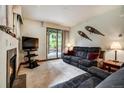 Comfortable living room with fireplace and sliding glass door to the backyard at 34 Highfield Trl # 112, Breckenridge, CO 80424