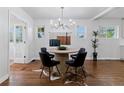 Elegant dining room featuring a round table, modern chandelier, and stylish decor at 4003 Federal Blvd, Denver, CO 80211