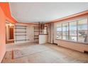 Bright living room featuring large windows, shelving and carpeting at 1535 Findlay Way, Boulder, CO 80305