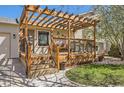 Inviting covered porch with wooden pergola, comfortable seating, and tasteful outdoor decor create a welcoming space at 1141 Beech St, Fort Lupton, CO 80621