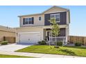 Lovely two-story home features a well-kept lawn, covered entry, and attached two-car garage at 1063 Gianna Ave, Fort Lupton, CO 80621