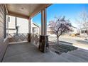 Inviting covered front porch featuring stone columns, decorative railings, and ample space for seating at 17086 E 106Th Ave, Commerce City, CO 80022