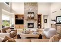 Cozy living room with a stone fireplace, built-in shelving, and comfortable seating at 12775 Horizon Trl, Castle Pines, CO 80108