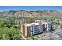 A multi-Gathering apartment complex with individual balconies and mature landscaping against a mountain backdrop at 1150 Golden Cir # 409, Golden, CO 80401