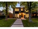 Contemporary two-story home with a landscaped yard and walkway leading to the front door at 1241 S Garfield St, Denver, CO 80210