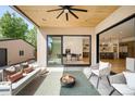 Covered patio features a wood ceiling, fire pit, and outdoor seating area, perfect for relaxing at 1241 S Garfield St, Denver, CO 80210
