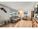 Cozy living room with hardwood floors, comfortable seating, and natural light from a window at 755 Braun St, Lakewood, CO 80401