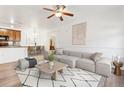 Bright living room with modern decor, stylish rug, and a comfortable sectional sofa at 2705 S Danube Way # 101, Aurora, CO 80013
