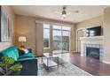 Cozy living room with fireplace, hardwood floors, and balcony access at 10184 Park Meadows Dr # 1303, Lone Tree, CO 80124