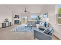 Bright living room with a cozy fireplace, large windows offering beautiful views, and stylish neutral-toned furniture at 1100 Columbine Way, Erie, CO 80516