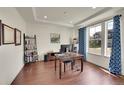 Bright home office with hardwood floors, large windows and elegant tray ceilings at 6335 E 143Rd Dr, Thornton, CO 80602