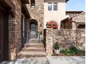 View of the home's entryway with stone facade and landscaped surroundings at 9151 E Harvard Ave, Denver, CO 80231