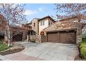 Lovely stone home with a terracotta roof and a three car garage at 9151 E Harvard Ave, Denver, CO 80231