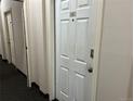 A hallway with carpet and neutral-colored walls, featuring a white door labeled '1C' at 3233 Vallejo St # 1C, Denver, CO 80211