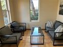 Comfortable seating area with plush gray furniture and a modern glass coffee table at 3233 Vallejo St # 1C, Denver, CO 80211