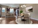 Eat-in kitchen with modern appliances, island seating, and a cozy dining area at 7887 Vallagio Ln, Englewood, CO 80112