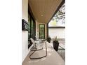 Covered front porch with stylish seating, offering a relaxing outdoor space at 62 Jasmine St, Denver, CO 80220