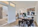 Cozy dining area with a round table, modern chairs, and stylish lighting fixtures at 4910 W 34Th Ave, Denver, CO 80212
