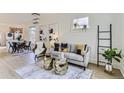Bright living room featuring neutral decor, hardwood floors, and stylish furnishings at 4910 W 34Th Ave, Denver, CO 80212