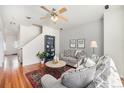 Bright living room boasting hardwood floors, stylish furniture, and a ceiling fan at 8381 E 29Th Ave, Denver, CO 80238