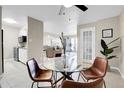 Dining area with glass table and chairs, open to kitchen and living room at 2 Adams St # 901, Denver, CO 80206