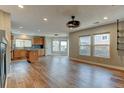 Bright living room with hardwood floors, modern lighting, and large windows offering ample natural light and neighborhood views at 3769 Dahlia St, Denver, CO 80207