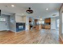 Open-concept living space with hardwood floors, modern fireplace, and seamless flow into the kitchen area at 3769 Dahlia St, Denver, CO 80207