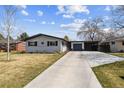 Charming single Gathering home featuring a brick exterior, attached garage and a well-manicured front yard at 794 S Ivy St, Denver, CO 80224