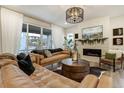 Living room with a fireplace, hardwood floors, and modern decor at 6950 Hidden Cove Ct, Castle Pines, CO 80108