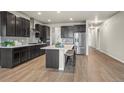 Spacious kitchen with island, stainless steel appliances, and an open floor plan at 1677 Meagan Way, Erie, CO 80516