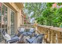 Cozy balcony featuring stylish outdoor seating and views of the neighborhood at 1950 N Logan St # 108, Denver, CO 80203