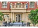 Elegant brick building facade with a private balcony and column-lined entrance at 1950 N Logan St # 108, Denver, CO 80203