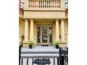 Grand front entrance with tall columns and elegant planters, highlighting the home's curb appeal at 1950 N Logan St # 108, Denver, CO 80203