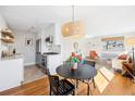 Open living space with updated kitchen, dining area, and comfortable seating arrangement at 525 Jackson St # 303, Denver, CO 80206