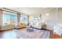Bright living room with large windows, hardwood floors and stylish furnishings at 172 Painted Horse Way, Erie, CO 80516
